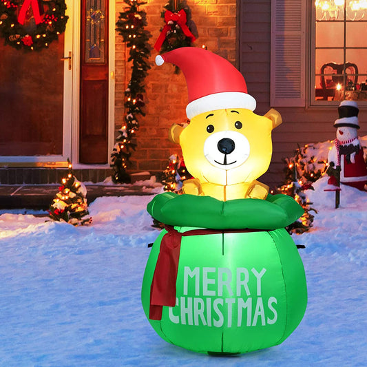 The Christmas inflatable displayed on a snowy garden path in front of a house at night