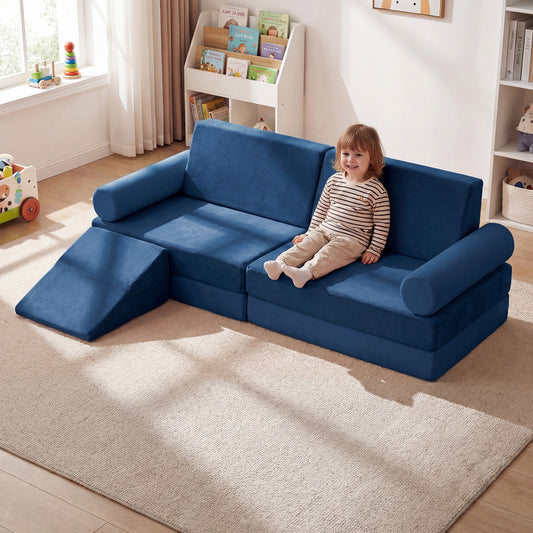The blue foam playset with a child sitting on the corner seat, in a bright room