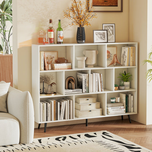The white bookcase is shown in a living room setting, filled with books and decorative items