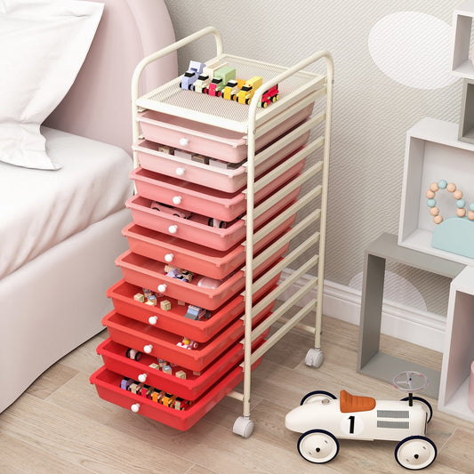 The file cabinet placed in a bedroom next to a bed with toys stored inside the drawers