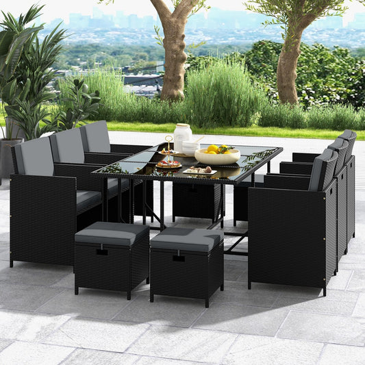The patio dining set with ottomans arranged around a table on a paved patio