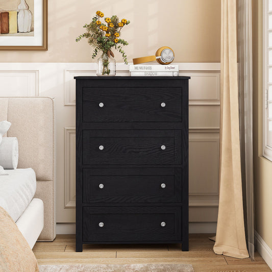 Black chest of drawers with four drawers, shown in a bedroom setting