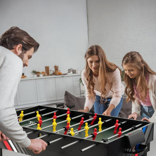 Family playing foosball on the 4-in-1 multi games table in a living room
