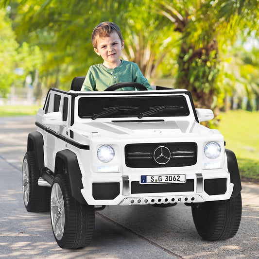 The kids electric car being driven by a young boy on a paved path