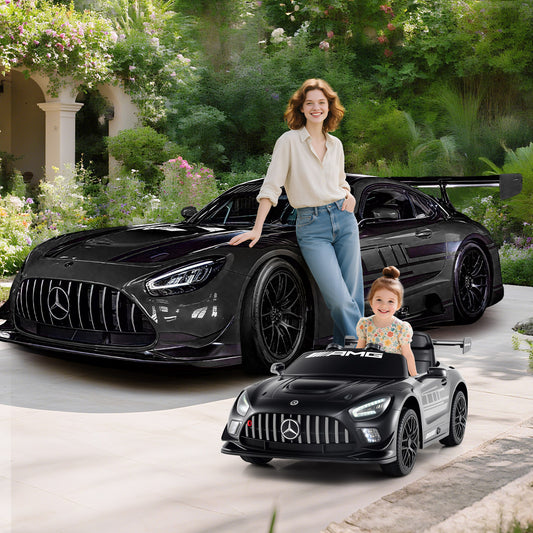 Mother and child with the black kids electric car Benz GT3 in a garden setting
