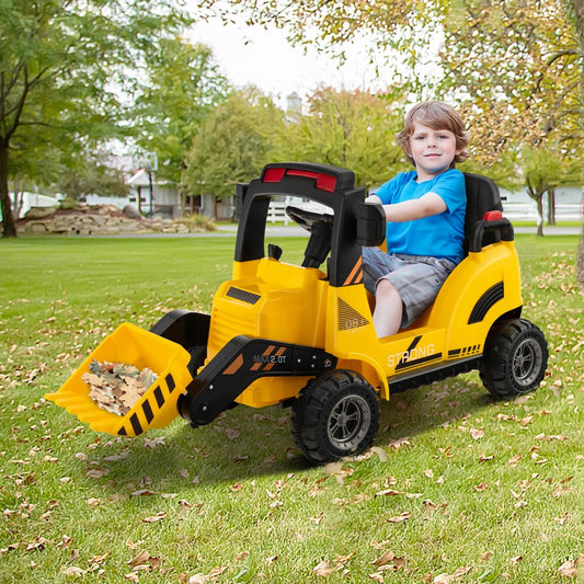 Young boy driving the yellow kids electric tractor in a garden