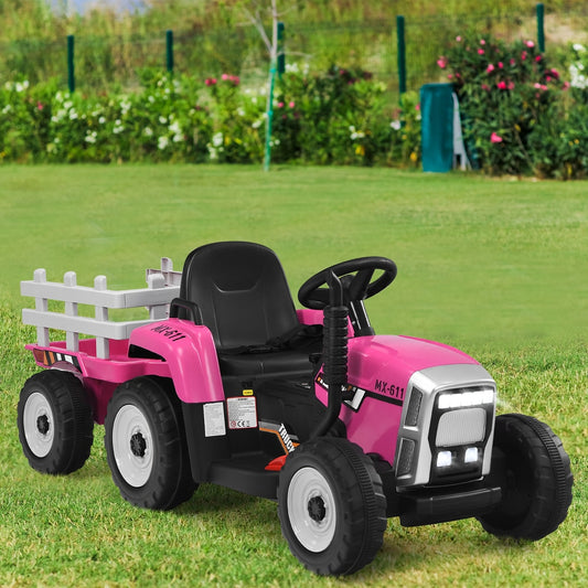 The pink kids electric tractor with a detachable trailer parked on a grassy lawn