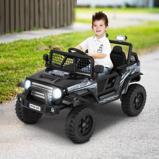 A black kids ride on truck car with a young boy driving it on a paved path