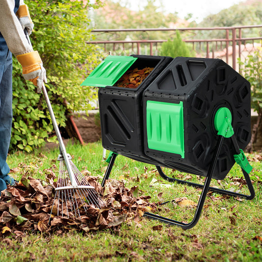 Gardener raking leaves into the tumbling composter in a garden setting