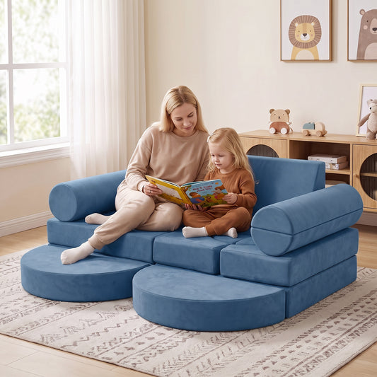 The blue modular kids play couch arranged as a sofa with a woman and child reading on it