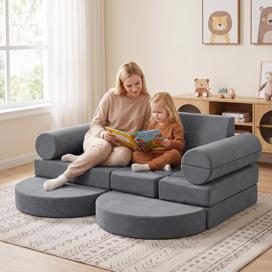 A grey modular kids play couch assembled into a fort with a child inside