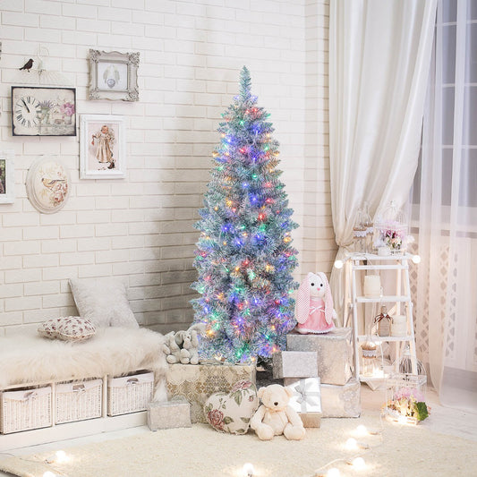 The slim pencil Christmas tree decorated with colourful lights in a cosy room setting
