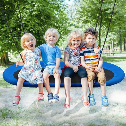 Four children sitting together on the blue oval swing in a sunny garden setting