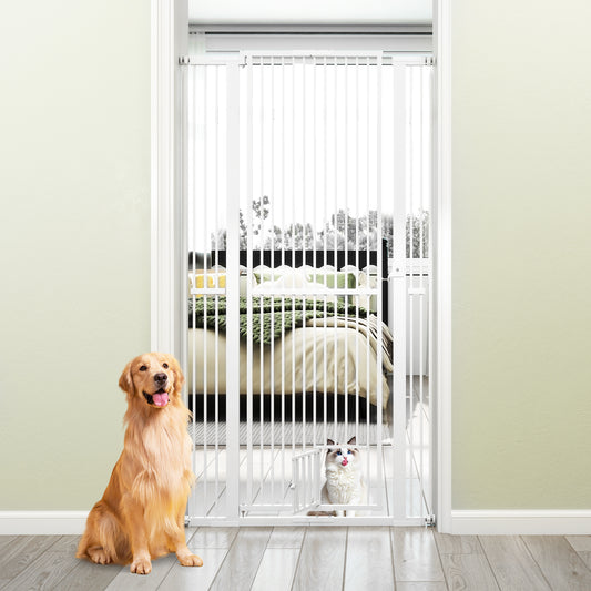 The tall white metal pet gate is installed in a doorway with a golden retriever and a cat sitting in front of it