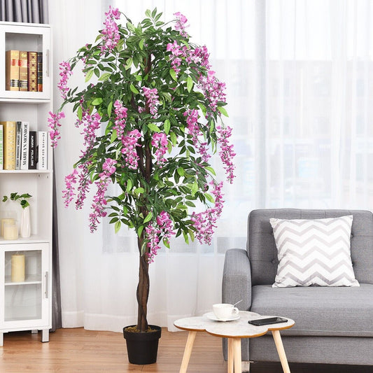 The artificial ficus tree placed in a modern living room next to a sofa and bookshelf