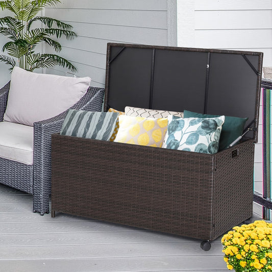 The patio rattan storage container filled with cushions on a decking area