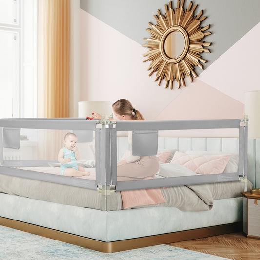 The bed rail installed on a large bed with a mother and baby sitting inside the enclosure