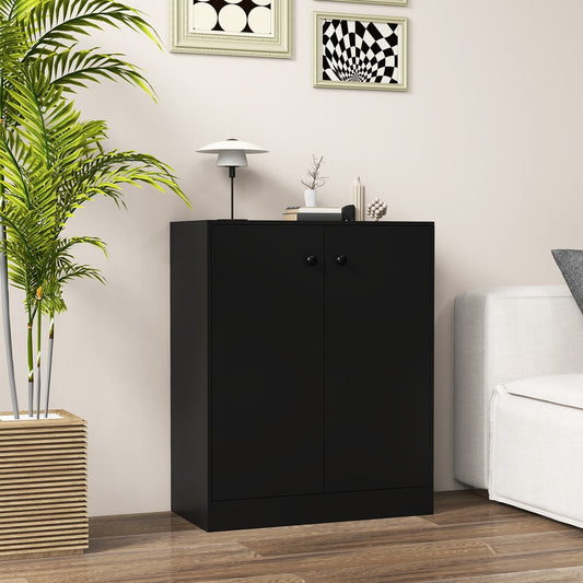 The black cabinet placed in a living room next to a sofa and a tall green plant