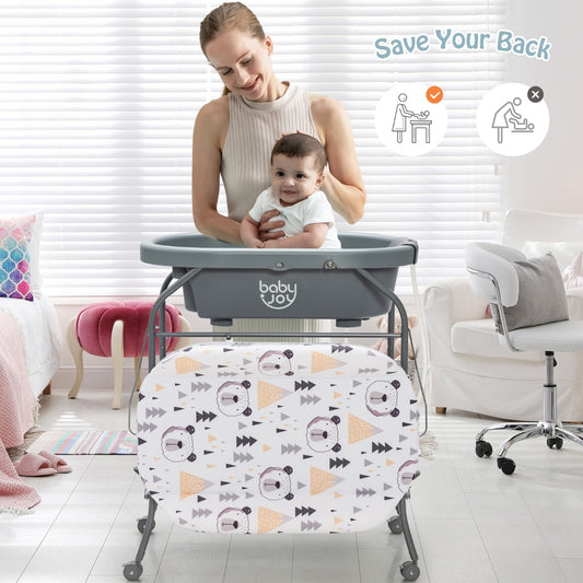 The changing table in use with a mother holding her baby in the bath tub section