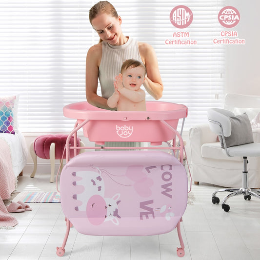 The changing station in use with a mother bathing her baby in the pink tub