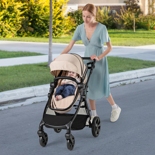 The baby stroller being pushed by a woman along a path with a baby sitting inside