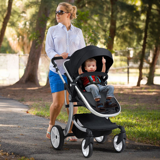 Woman pushing a black baby stroller with a child sitting in the seat