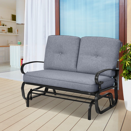 The patio glider chair placed on a wooden deck next to a glass door