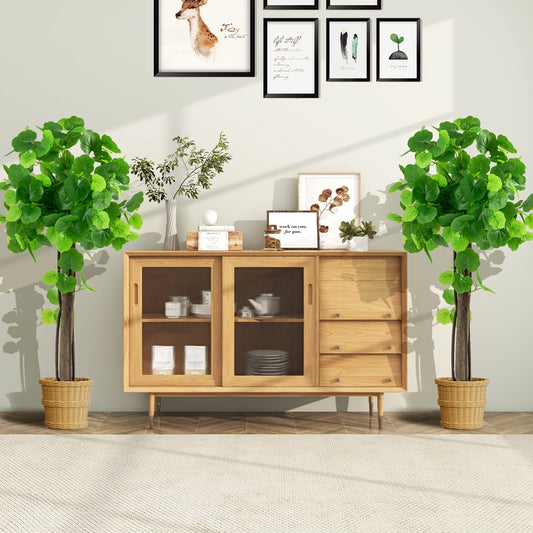 Two artificial crabapple trees in pots placed either side of a wooden cabinet in a living room