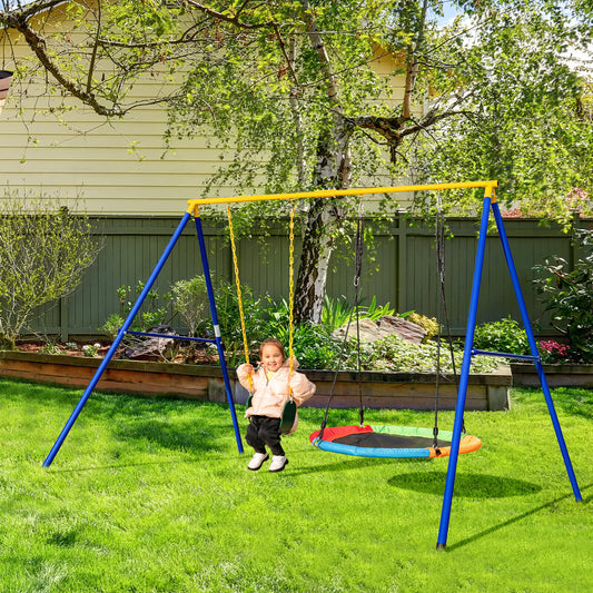 The swing set in a garden with a child on the green strap swing seat