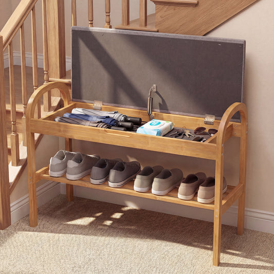 The shoe bench placed in a hallway with shoes stored on the shelf and items inside the open seat
