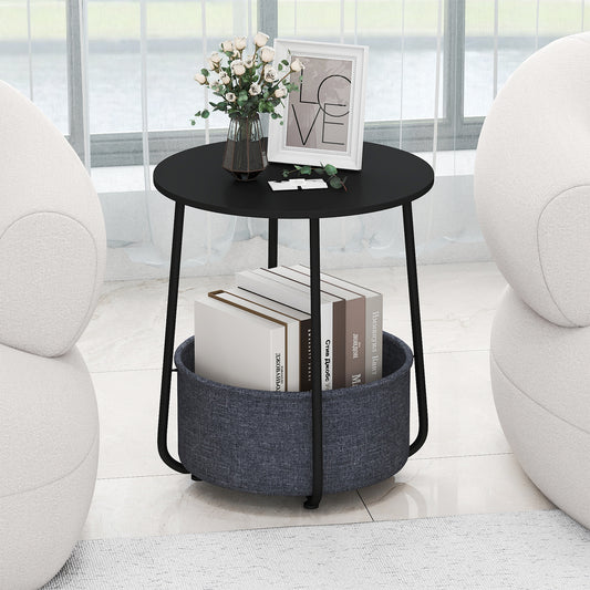 The end table with books and a vase of flowers in the fabric basket, next to a window