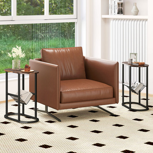 Two slim oval end tables with magazine racks placed next to a brown leather armchair in a living room