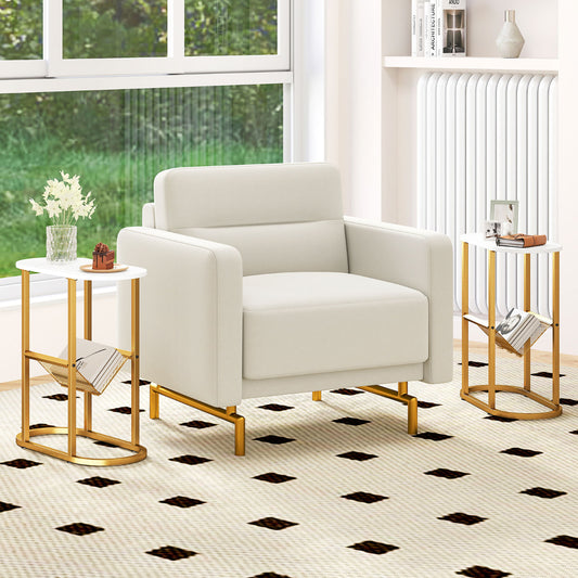 The end tables placed on either side of a cream armchair in a bright living room setting