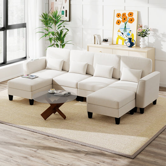 The white sectional sofa is arranged in a living room with a coffee table and plants