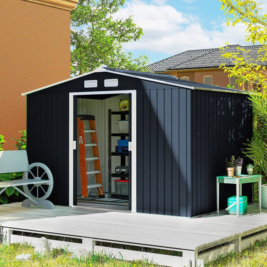 The garden shed placed on a wooden deck in a garden with a ladder and shelves inside