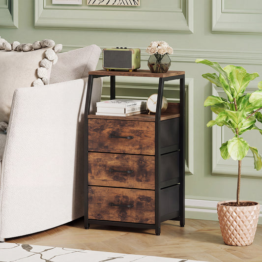 The storage dresser placed in a living room next to a sofa with a plant and decor on top