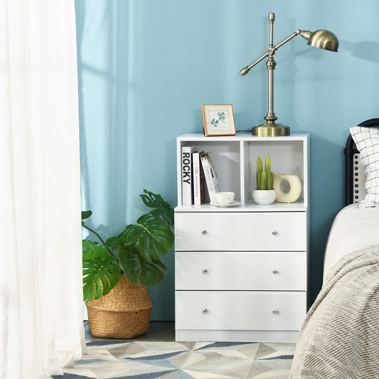 White 3-drawer dresser with open compartments in a bedroom setting next to a bed