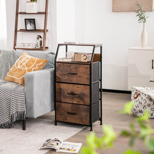 the brown storage chest stands on a wooden floor next to a grey sofa in a bright living room