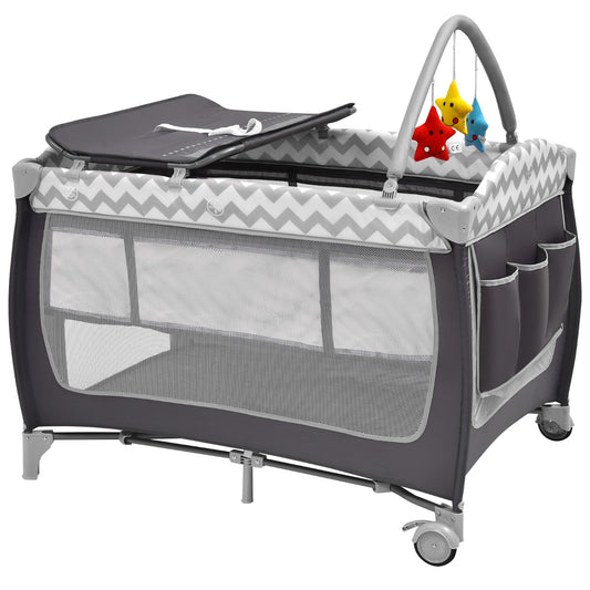 Grey baby playpen with a changing mat and hanging toys