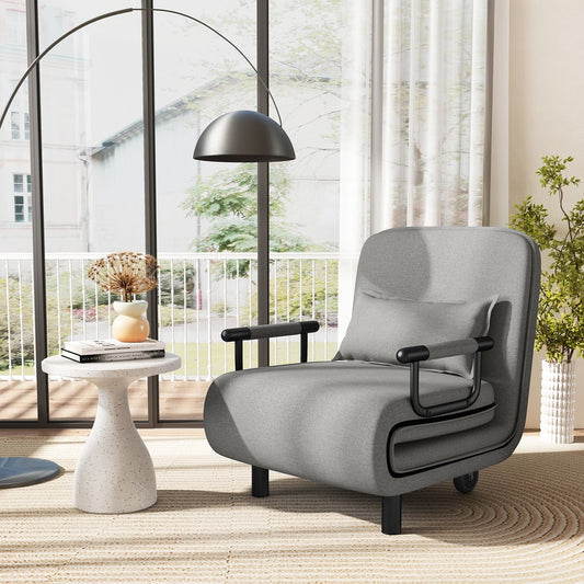 The light grey sofa bed with a small matching pillow sitting on a rug in a bright room