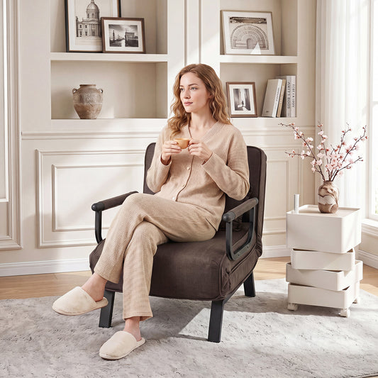 Woman relaxing in a brown sofa bed in a living room