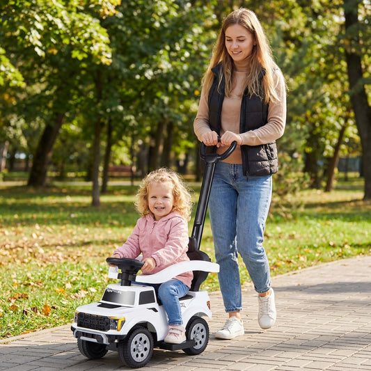 Woman pushing a toddler sitting in the white push car in a park