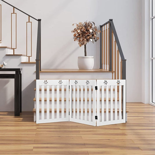 The white pet gate is set up at the bottom of a staircase in a modern home