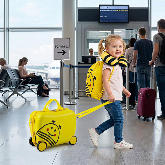The yellow kids luggage set with a bee face design being pulled by a child in an airport terminal