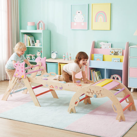 Two toddlers playing on the macaron coloured climbing frame in a nursery room