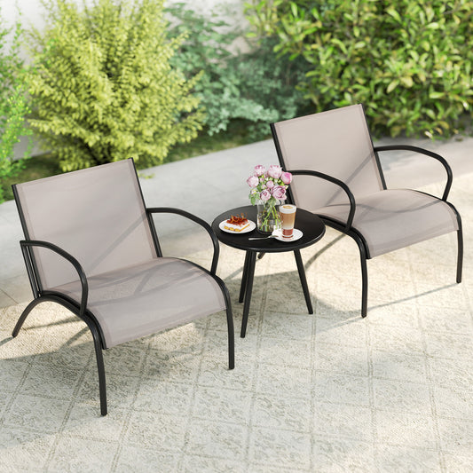 The patio furniture set placed on a patio rug with a vase of flowers and coffee on the table