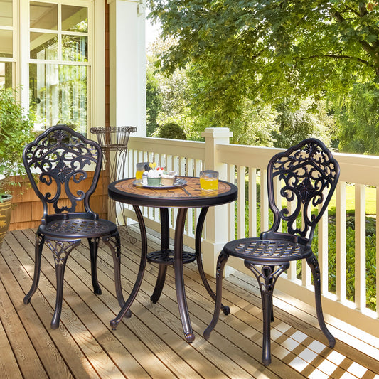 The patio furniture set arranged on a wooden porch with a green garden background