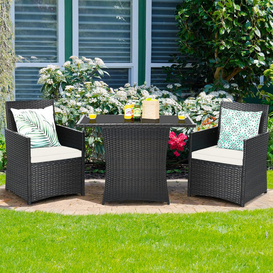 The patio furniture set placed on a paved garden path with green plants