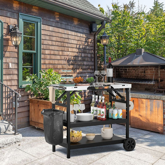 the outdoor grill cart placed on a stone patio next to a wooden house wall