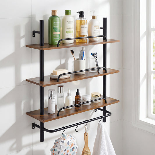 The three-tier industrial floating shelves in a bathroom setting with toiletries and towels